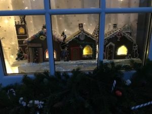 Image of 3 houses lit from behind in the window frame