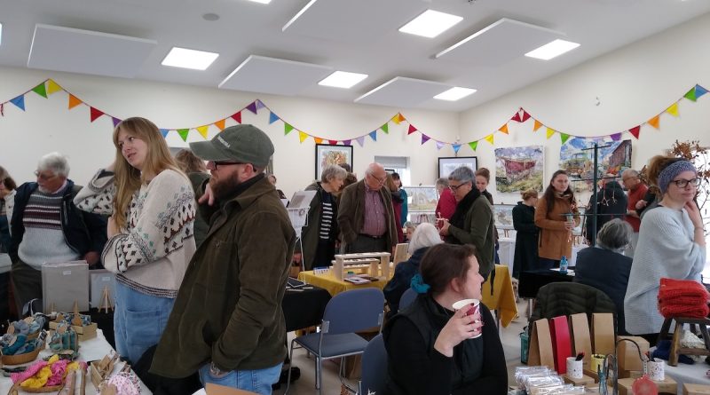 Villagers exploring the craft stalls in the Memorial Hall