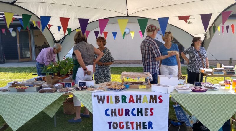People at the produce stall run by Wilbraham's Churches Together at the Farmers market